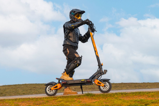 Adult rider on an off-road electric scooter wearing protective gear