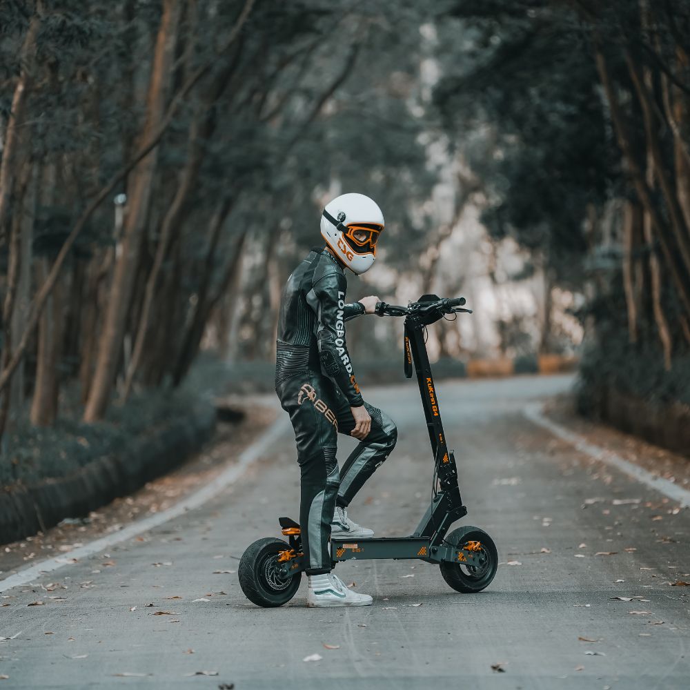 Electric scooters for adults showing wide deck and heavy-duty suspension